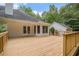 Wooden deck with backyard views of house exterior and trees at 1721 Druids Se Xing, Conyers, GA 30013