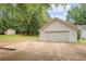 This property includes a two-car garage and lengthy driveway with a shed visible on the lawn behind it at 1721 Druids Se Xing, Conyers, GA 30013