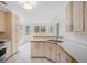 Bright kitchen featuring white cabinets, white tile flooring, breakfast nook with many windows for viewing the backyard at 1721 Druids Se Xing, Conyers, GA 30013