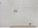 Empty laundry room with white walls, tile flooring, utility hookups and wire shelving for storage at 1721 Druids Se Xing, Conyers, GA 30013