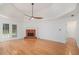 Spacious living room featuring a fireplace, hardwood floors, and access to the outdoor deck at 1721 Druids Se Xing, Conyers, GA 30013