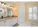 Bright bathroom featuring double vanity with granite countertop and white cabinets at 5 Renfroe Ct, Decatur, GA 30030