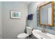 Powder room featuring a vanity, toilet, decorative mirror, and blue paint at 5 Renfroe Ct, Decatur, GA 30030
