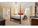 Bright bedroom with a four-poster bed, yellow walls, plantation shutters, and en-suite bath access at 5 Renfroe Ct, Decatur, GA 30030