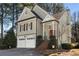 Two story home with a two-car garage, brick stairs to the front door, and a screen porch on the side at 5 Renfroe Ct, Decatur, GA 30030