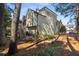 Exterior view of home with beautiful green siding, mature trees, and private backyard at 5 Renfroe Ct, Decatur, GA 30030