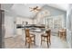 Bright kitchen with white cabinets, granite countertops, and stainless steel appliances, plus an island with bar seating at 5 Renfroe Ct, Decatur, GA 30030