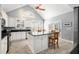 Bright kitchen with stainless appliances, granite counters and an island with seating under a vaulted ceiling at 5 Renfroe Ct, Decatur, GA 30030