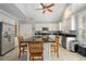 Bright kitchen with stainless appliances, granite counters and an island with seating under a vaulted ceiling at 5 Renfroe Ct, Decatur, GA 30030