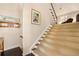 Carpeted staircase with wood railing leading to upper level with view of upper landing at 5 Renfroe Ct, Decatur, GA 30030
