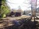 View of a wooden porch and home in a spacious, wooded backyard at 727 Regina Ct, Lawrenceville, GA 30043