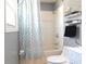 Well-lit bathroom with a shower-tub combo, modern fixtures, and a stylish shower curtain at 727 Regina Ct, Lawrenceville, GA 30043