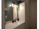 Bathroom with a modern light fixture and neutral countertops at 727 Regina Ct, Lawrenceville, GA 30043