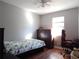 Cozy bedroom with wood floors, ceiling fan, and natural light from the window at 727 Regina Ct, Lawrenceville, GA 30043
