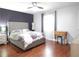 Spacious bedroom features wood floors, a decorative accent wall, and a comfortable bed at 727 Regina Ct, Lawrenceville, GA 30043