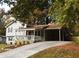 View of the home's exterior, including a long driveway and a covered carport at 727 Regina Ct, Lawrenceville, GA 30043