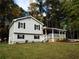 Charming two-story home with well-maintained lawn, dark shutters, and covered porch at 727 Regina Ct, Lawrenceville, GA 30043