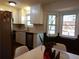 Bright kitchen with white cabinets, stainless steel appliances, and a bay window at 727 Regina Ct, Lawrenceville, GA 30043