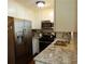 Kitchen with stainless steel appliances, granite countertops, and white cabinets at 727 Regina Ct, Lawrenceville, GA 30043