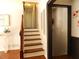 Traditional stairway with wooden handrail and trim, leading to the upper level at 727 Regina Ct, Lawrenceville, GA 30043