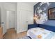 This bedroom features a moon wall design, hardwood floors, and a double door closet for ample storage space at 1765 Beckham Ne Pl # 53, Atlanta, GA 30324