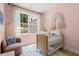 Charming Bedroom with a cozy chair, light pink walls and bright window at 1765 Beckham Ne Pl # 53, Atlanta, GA 30324