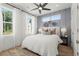 Stylish bedroom with board and batten accent wall and bright windows at 1765 Beckham Ne Pl # 53, Atlanta, GA 30324