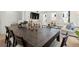 Open concept dining room with table for eight and view to the living room at 1765 Beckham Ne Pl # 53, Atlanta, GA 30324