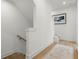 Hallway with hardwood floors and staircase leading to another level, enhanced by modern art and an area rug at 1765 Beckham Ne Pl # 53, Atlanta, GA 30324