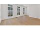 Sunlit room with hardwood floors, large windows, and a walkout door to the outside at 1765 Beckham Ne Pl # 53, Atlanta, GA 30324