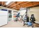 Finished basement with gym equipment, fridge, carpet and exposed ceiling at 1894 Whitehawk Ct, Lawrenceville, GA 30043