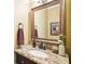 Bathroom vanity with granite countertops, decorative fixtures, and a beautiful decorative mirror at 1894 Whitehawk Ct, Lawrenceville, GA 30043