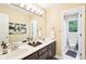 Bathroom boasts double sink vanity, modern lighting fixtures, a large mirror, and a connected toilet room at 1894 Whitehawk Ct, Lawrenceville, GA 30043