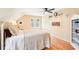 Bedroom features hardwood floors, light walls, a modern ceiling fan, and a white metal bedframe at 1894 Whitehawk Ct, Lawrenceville, GA 30043