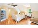 Bedroom features wood floors, light walls, a modern ceiling fan, and a white metal bedframe at 1894 Whitehawk Ct, Lawrenceville, GA 30043
