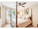 Bedroom with neutral walls, four poster bed, ceiling fan, and natural light from the window at 1894 Whitehawk Ct, Lawrenceville, GA 30043