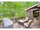 Inviting deck with seating and outdoor dining, overlooking a lush, wooded backyard at 1894 Whitehawk Ct, Lawrenceville, GA 30043
