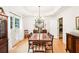 Formal dining room with wooden table, elegant chandelier, and views of the entryway at 1894 Whitehawk Ct, Lawrenceville, GA 30043