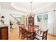 Formal dining room with hardwood floors, tray ceiling, and elegant chandelier at 1894 Whitehawk Ct, Lawrenceville, GA 30043