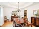 Elegant dining room with hardwood floors, chandelier, wainscoting, and tray ceiling at 1894 Whitehawk Ct, Lawrenceville, GA 30043