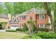 Beautiful brick home with lush landscaping, mature trees, and an attached garage at 1894 Whitehawk Ct, Lawrenceville, GA 30043
