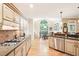 Gourmet kitchen boasts granite counters, stainless appliances, and a breakfast area with a beautiful window at 1894 Whitehawk Ct, Lawrenceville, GA 30043