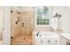 Elegant main bathroom with soaking tub, glass shower, and ample natural light at 1894 Whitehawk Ct, Lawrenceville, GA 30043