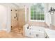 Elegant main bathroom with soaking tub and separate glass shower at 1894 Whitehawk Ct, Lawrenceville, GA 30043