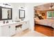 Bright, open main bathroom featuring double vanity and view into the main bedroom at 1894 Whitehawk Ct, Lawrenceville, GA 30043