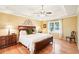 Bright main bedroom featuring a tray ceiling, hardwood floors, and large window at 1894 Whitehawk Ct, Lawrenceville, GA 30043