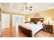 Spacious main bedroom features a tray ceiling, hardwood floors, and ensuite bathroom at 1894 Whitehawk Ct, Lawrenceville, GA 30043