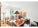 Bright home office features ample natural light, a large desk and comfortable seating at 1894 Whitehawk Ct, Lawrenceville, GA 30043