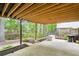 Covered patio featuring a concrete floor and view of the wooded backyard at 1894 Whitehawk Ct, Lawrenceville, GA 30043