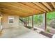 Covered patio with access to the backyard, surrounded by lush greenery at 1894 Whitehawk Ct, Lawrenceville, GA 30043
